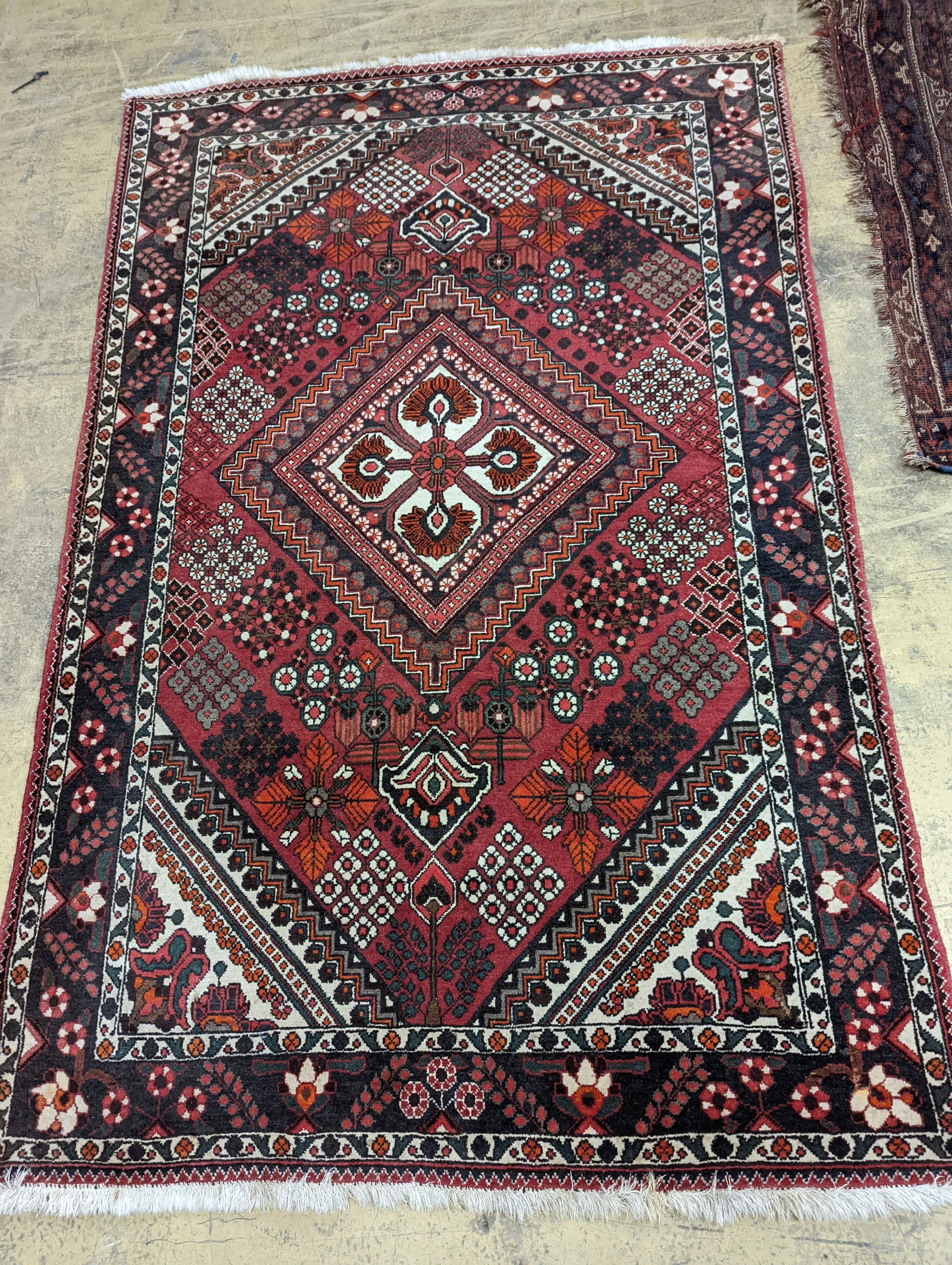 A North West Persian red ground rug, 200 x 130cm